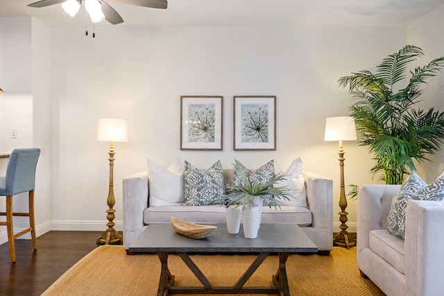 a%20living%20room%20with%20a%20tow-seater%20linen%20couch%20and%20matching%20arm%20chair